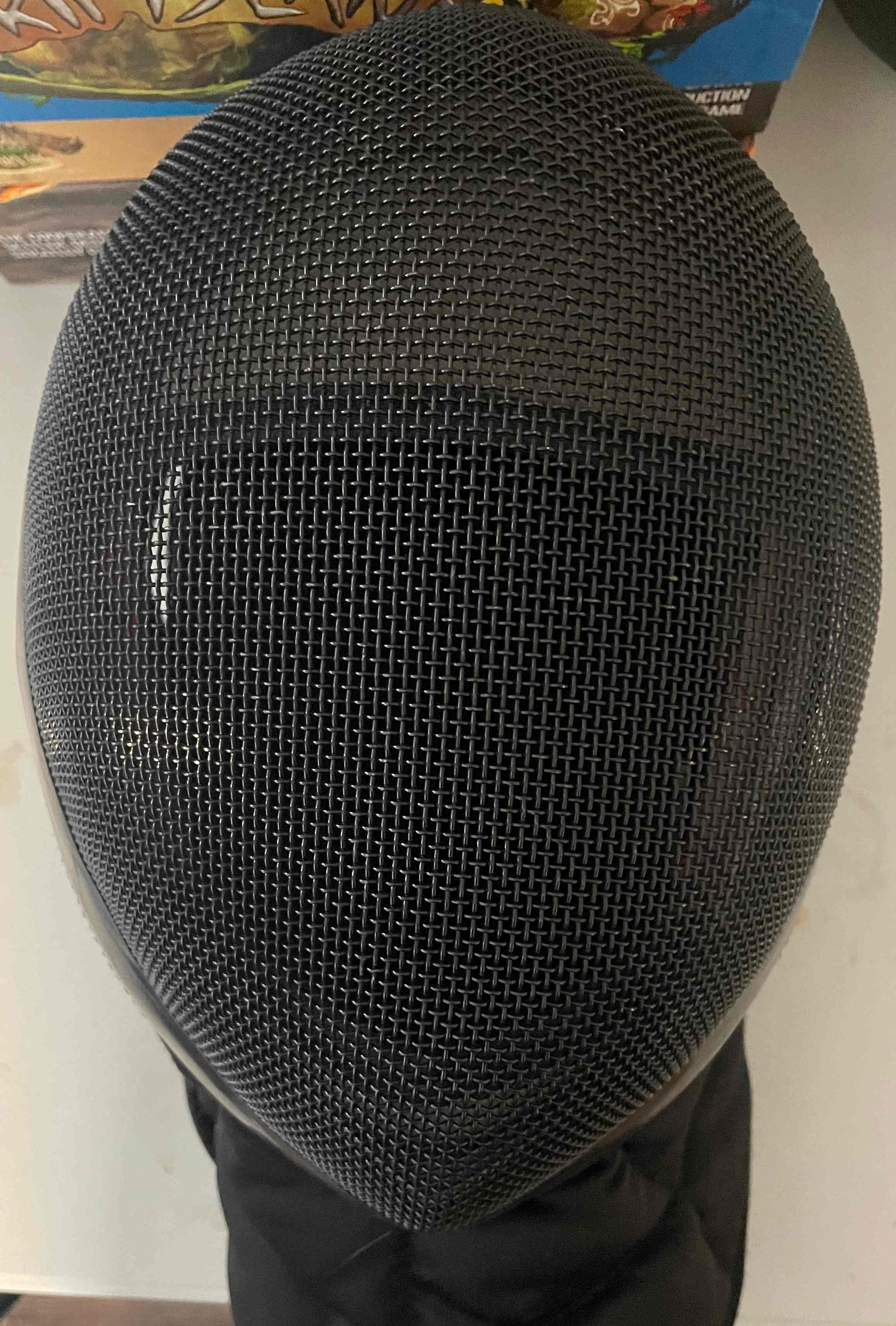 A black fencing mask.